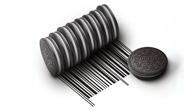 A stack of Oreos on their side being rolled to create a barcode, with a single flat Oreo next to them